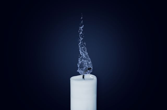 Biała świeca z knotem zalanym wodą